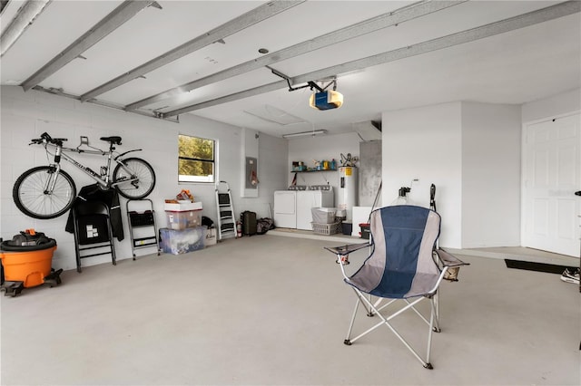 garage with water heater, a garage door opener, and independent washer and dryer