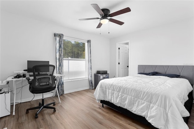 bedroom with light hardwood / wood-style flooring and ceiling fan