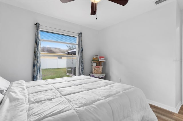 bedroom with ceiling fan and wood-type flooring