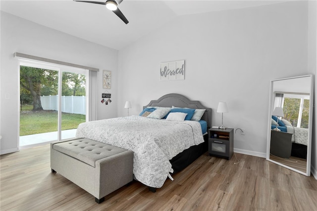 bedroom featuring hardwood / wood-style flooring, ceiling fan, access to outside, and multiple windows