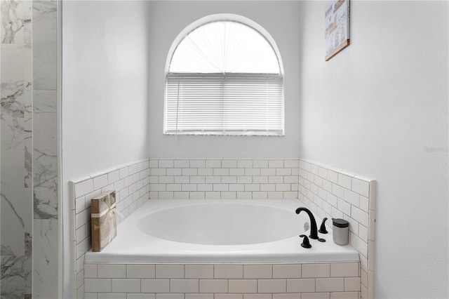 bathroom featuring a relaxing tiled tub