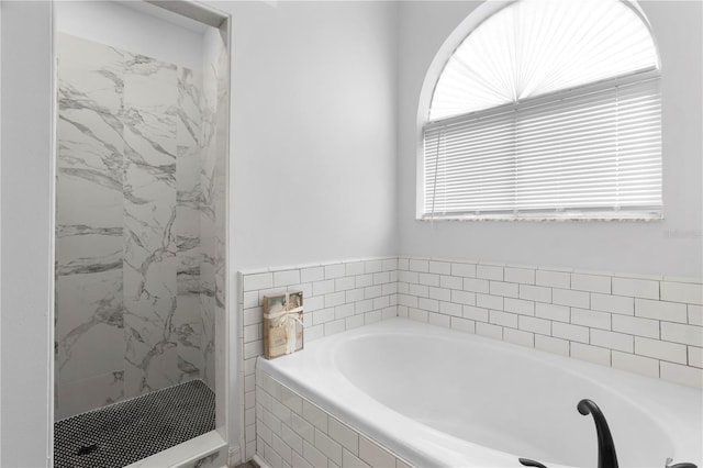 bathroom featuring separate shower and tub