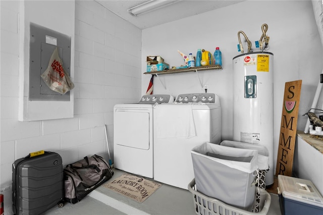 clothes washing area with separate washer and dryer, electric panel, and water heater