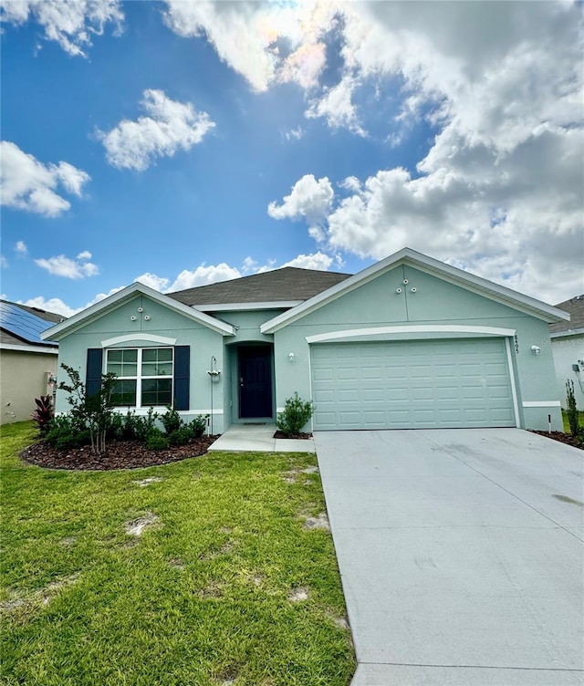 ranch-style house featuring a garage and a front lawn