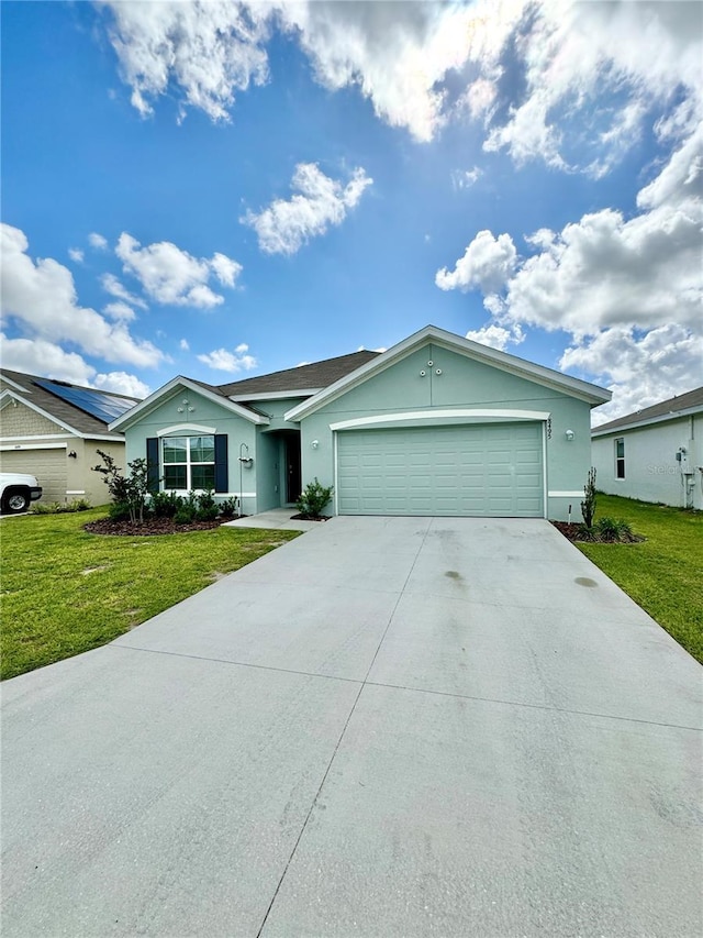 single story home featuring a garage and a front lawn