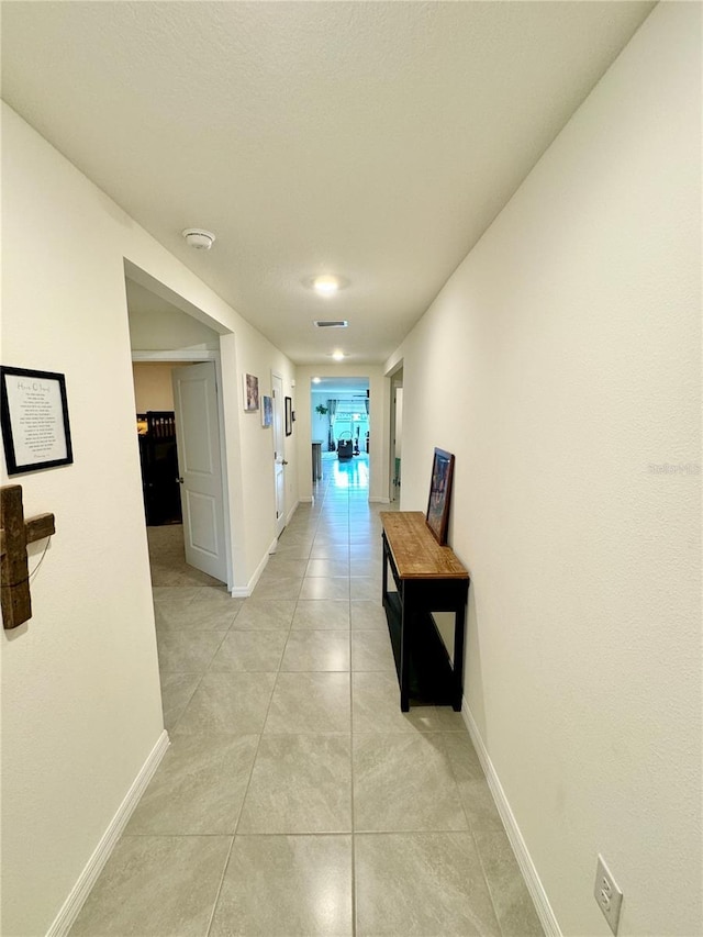 corridor with light tile patterned flooring