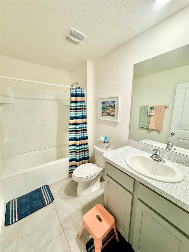 full bathroom featuring toilet, a textured ceiling, vanity, shower / bath combo with shower curtain, and tile patterned flooring