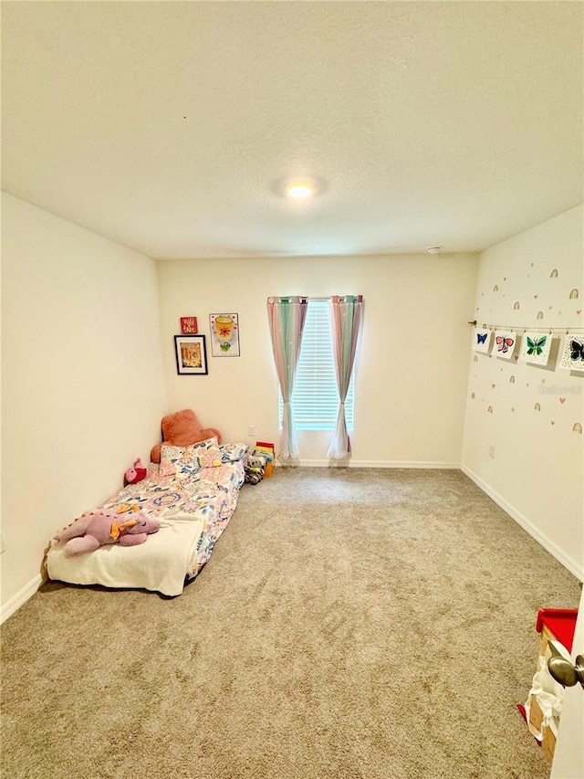 unfurnished bedroom featuring carpet floors and a textured ceiling