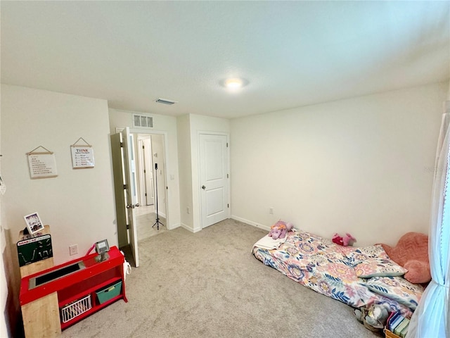 bedroom featuring light carpet