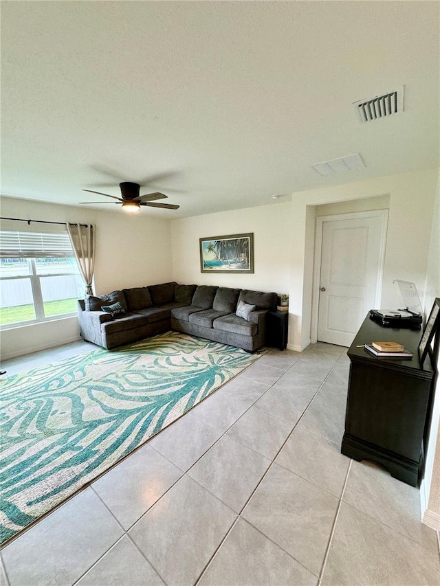 living room with light tile patterned floors and ceiling fan