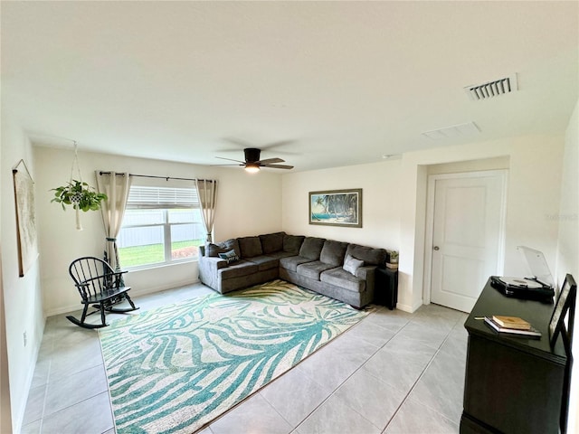 tiled living room with ceiling fan