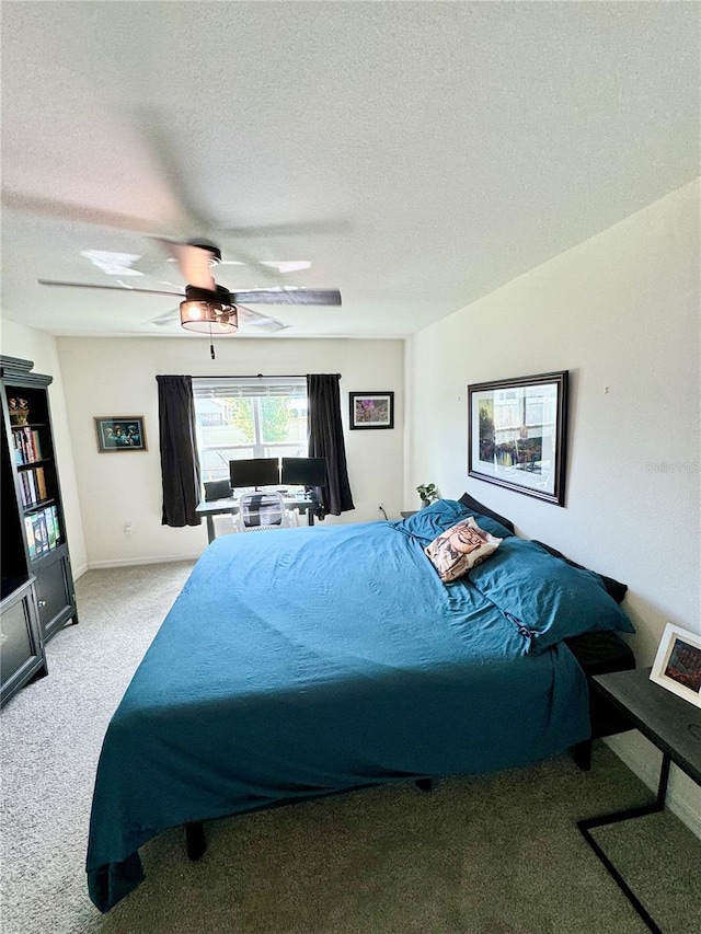 bedroom featuring ceiling fan, light carpet, and a textured ceiling