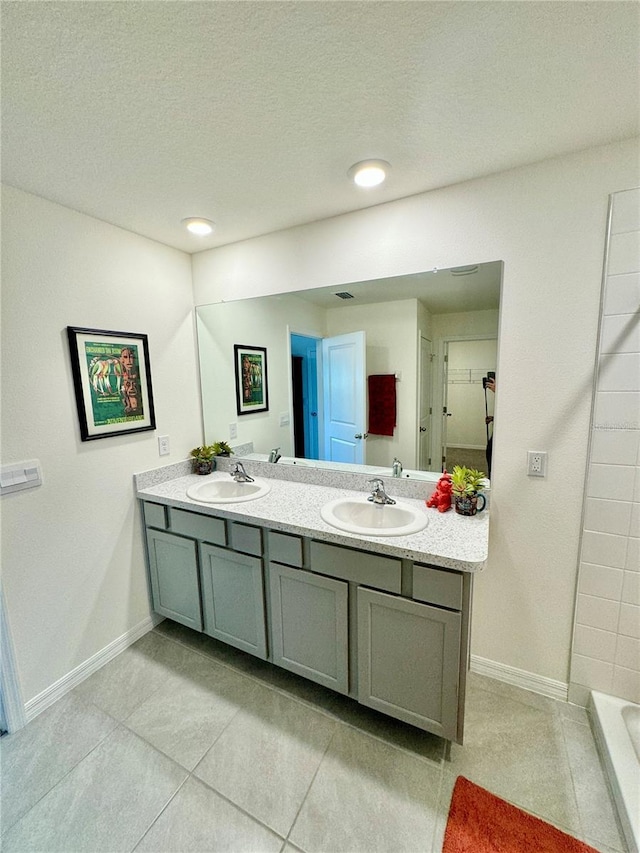 bathroom with vanity, tile patterned flooring, and a textured ceiling