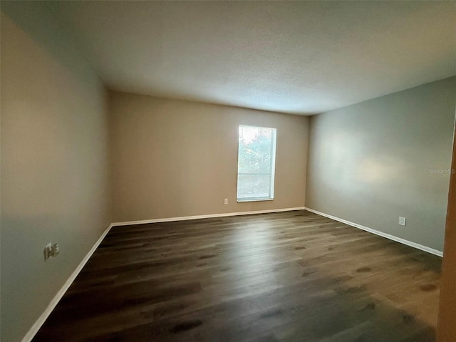 unfurnished room with dark hardwood / wood-style floors