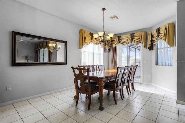 tiled dining area featuring a notable chandelier