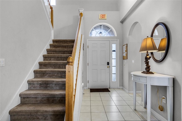 tiled foyer with a high ceiling