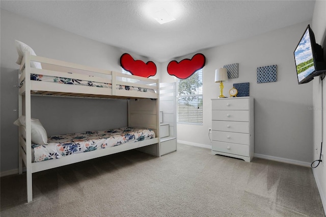 carpeted bedroom featuring a textured ceiling