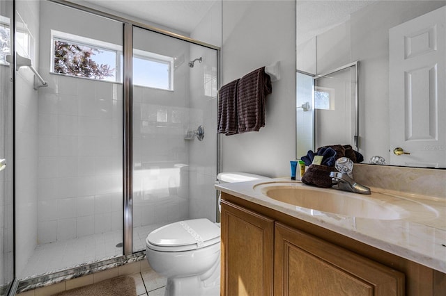 bathroom with tile patterned flooring, vanity, toilet, and a shower with shower door