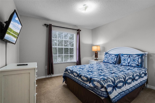 bedroom with carpet and a textured ceiling