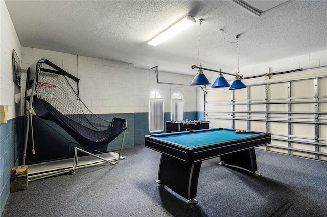 recreation room with a textured ceiling and pool table