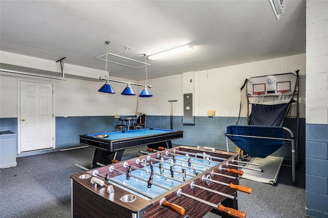 game room featuring electric panel, a textured ceiling, and billiards