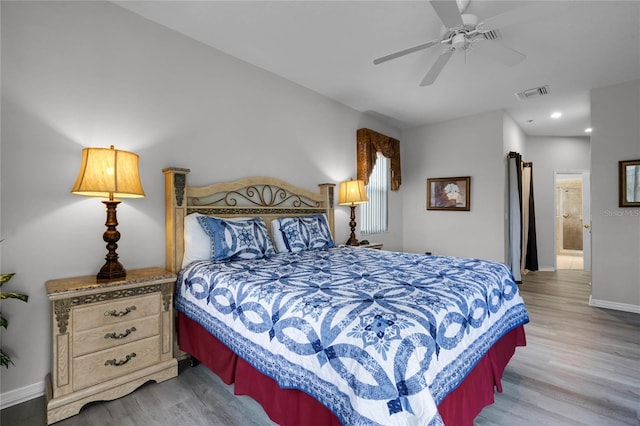 bedroom with ensuite bath, ceiling fan, and wood-type flooring