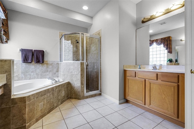 bathroom with tile patterned flooring, vanity, and shower with separate bathtub