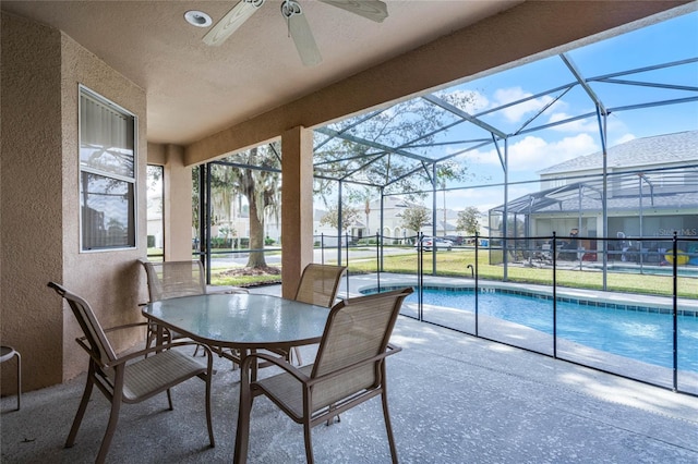 sunroom / solarium with ceiling fan and a swimming pool