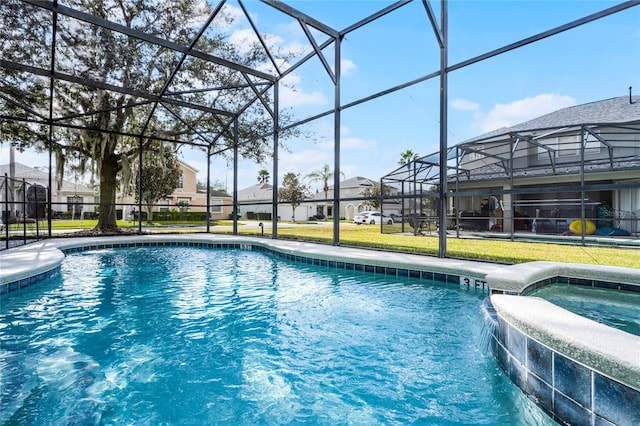 view of pool featuring pool water feature, a lanai, a yard, and an in ground hot tub