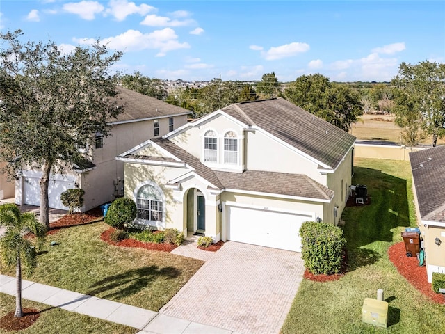 view of front property with a front yard and a garage