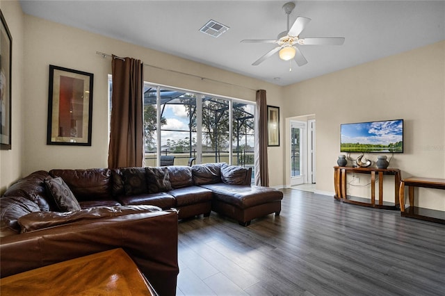 living room with ceiling fan and dark hardwood / wood-style flooring