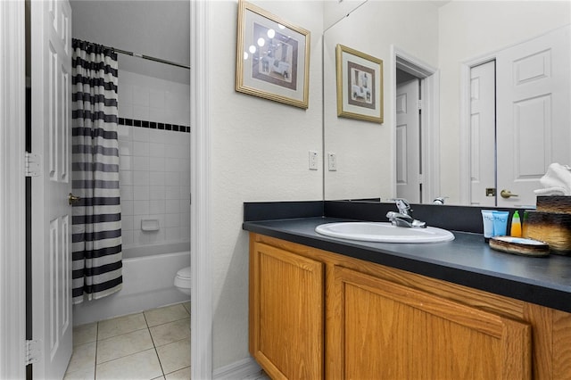 full bathroom featuring tile patterned floors, shower / bath combo with shower curtain, vanity, and toilet