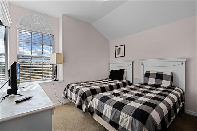 bedroom with carpet flooring, lofted ceiling, and multiple windows