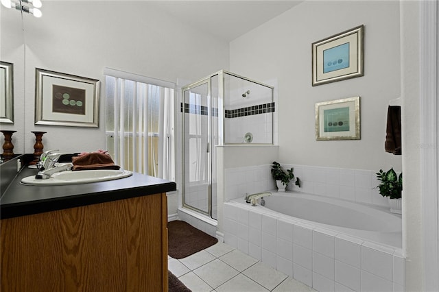 bathroom featuring tile patterned flooring, vanity, and plus walk in shower