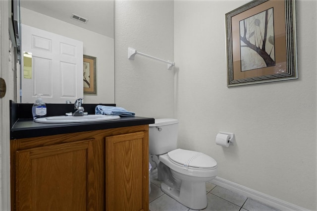 bathroom featuring toilet, vanity, and tile patterned floors