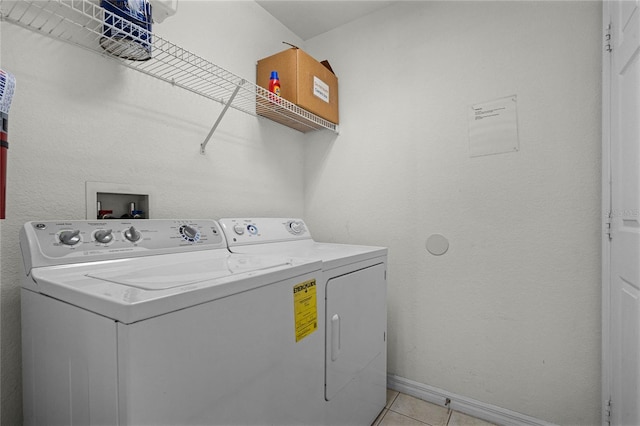 washroom featuring independent washer and dryer and light tile patterned floors