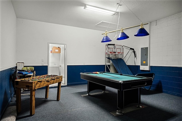 game room featuring washer / dryer, a textured ceiling, and electric panel