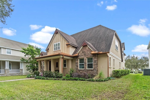 view of front of home featuring cooling unit and a front lawn