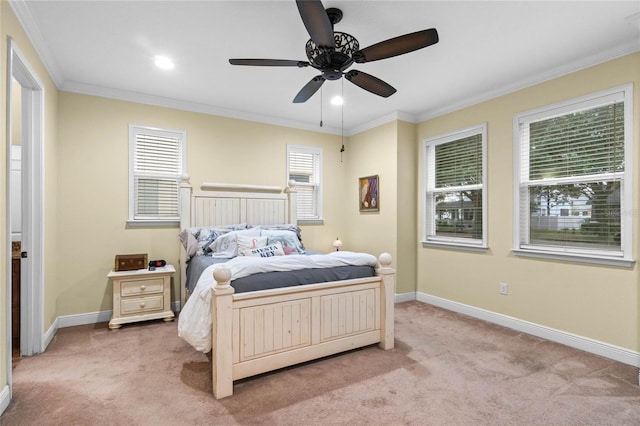 carpeted bedroom featuring ceiling fan and crown molding