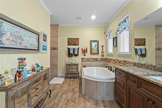 bathroom featuring a bath, crown molding, vanity, and wood-type flooring