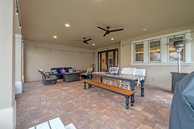 view of patio with an outdoor living space and ceiling fan