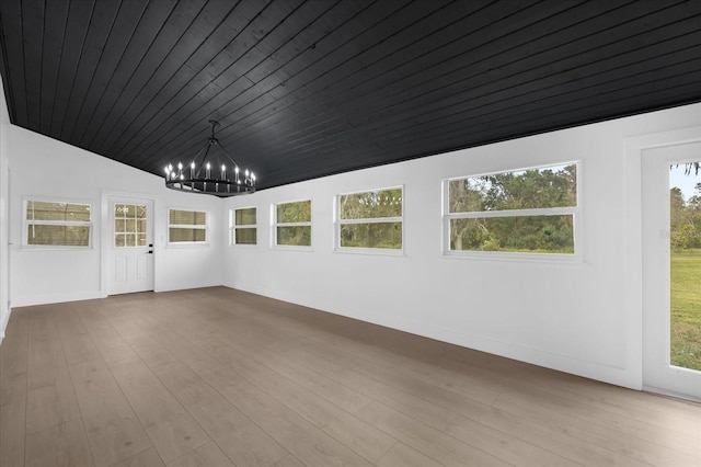 unfurnished room with wood ceiling, light hardwood / wood-style floors, lofted ceiling, and a notable chandelier