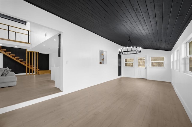 interior space featuring hardwood / wood-style flooring, an inviting chandelier, lofted ceiling, and wood ceiling