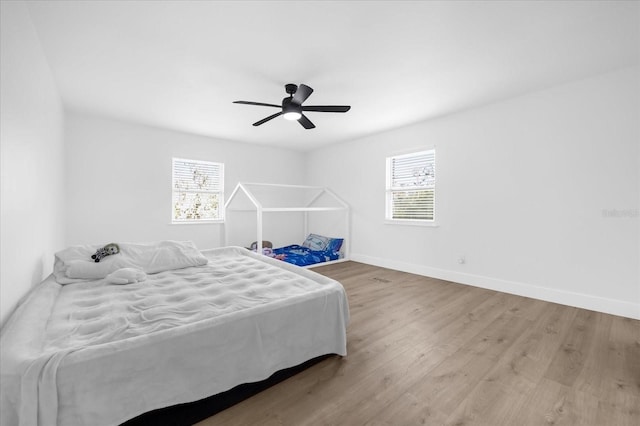 bedroom with ceiling fan and hardwood / wood-style floors