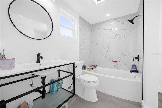 full bathroom with sink, tiled shower / bath combo, and toilet