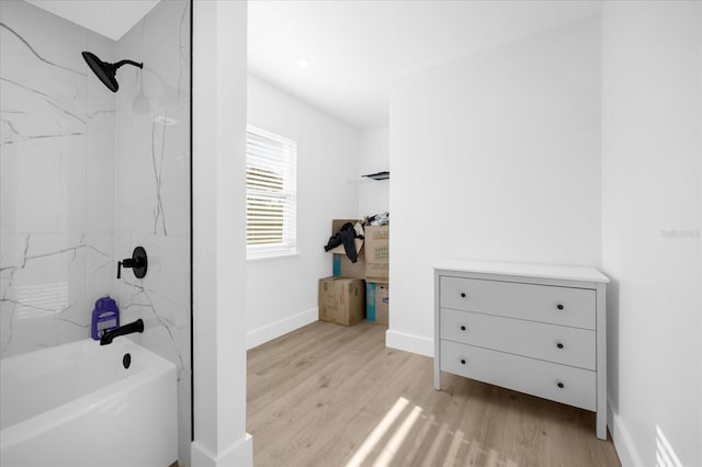 bathroom with shower / bathtub combination and hardwood / wood-style flooring