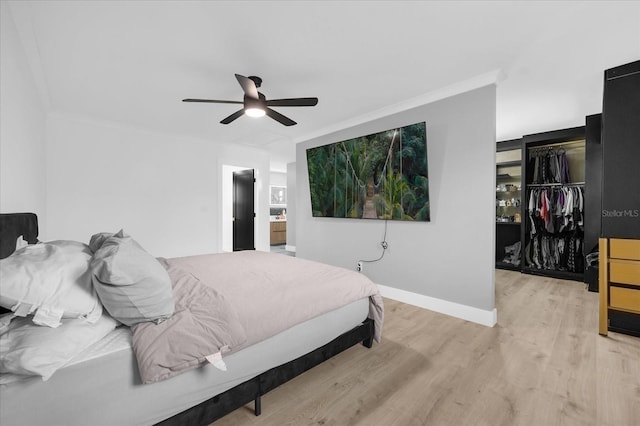 bedroom featuring ceiling fan, light hardwood / wood-style floors, and ornamental molding