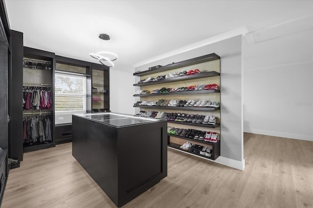 walk in closet featuring light hardwood / wood-style flooring