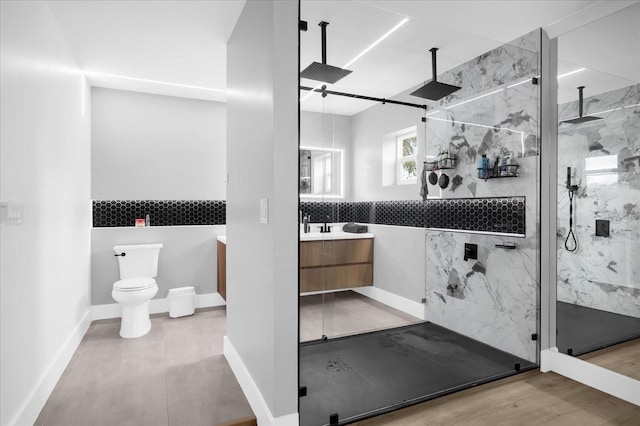 bathroom featuring vanity, backsplash, toilet, walk in shower, and wood-type flooring