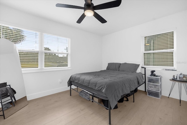 bedroom featuring ceiling fan and light hardwood / wood-style flooring